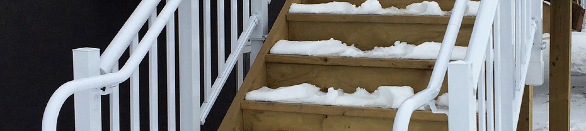 Staircase in winter with pipe railing system