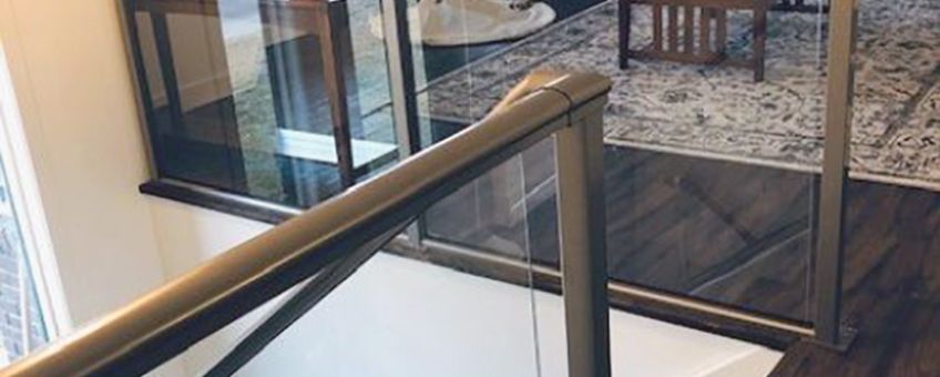 Framed glass stair railing in a living room